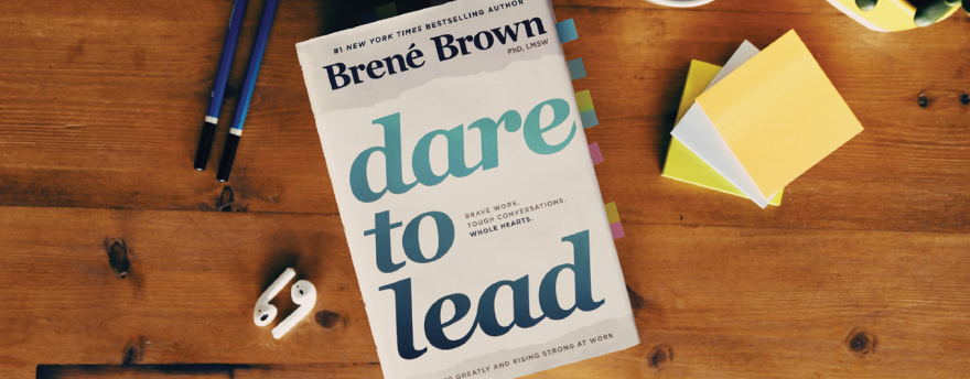 Dare to Lead book by Bren茅 Brown on a wooden table