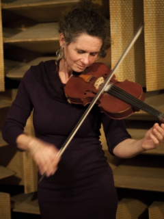 Photograph of Hazel Fairbairn playing the violin in studio